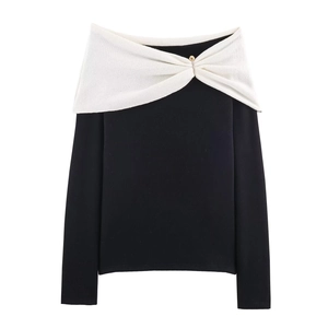 Detailed view of off-shoulder knit top with white contrast collar and gold buckle