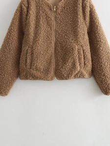 Close-up of brown sherpa fleece jacket featuring a gold zipper and plush texture