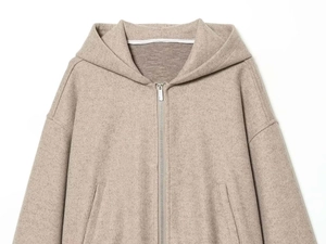 Close-up of oatmeal wool jacket showing premium felted texture and metal zipper detail
