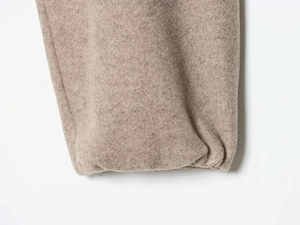 Close-up of soft oatmeal brushed knit fabric texture on the sleeve of a women set