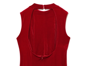 Detail of red velvet backless dress showing halter neck with drop-shaped cutout and zipper