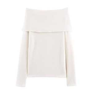 Detailed view of the soft knitted texture and off-shoulder neckline on white top