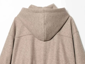 Detail view of oatmeal wool hoodie showing the back hood design and soft fabric texture