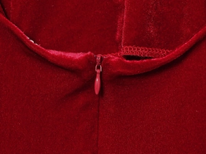 Detailed macro view of invisible zipper on dark red velvet sleeveless dress fabric
