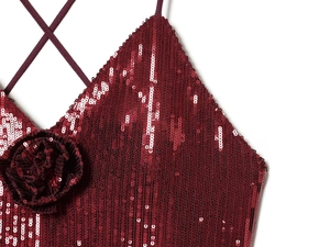 Detail of dark red sequin dress featuring a handmade 3D floral accent and thin straps