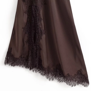 Close-up of dark brown satin dress hem featuring delicate eyelash lace trim and silk finish