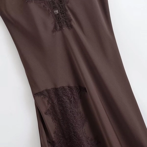 Close-up of deep brown satin dress featuring delicate black eyelash lace trimmings