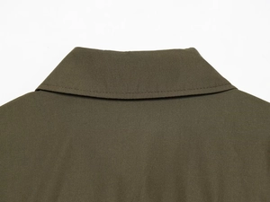 Close-up of olive green poplin shirt collar featuring clean stitching and twill texture