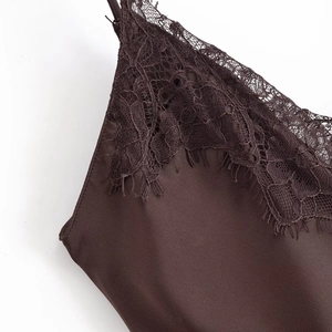 Detail of deep brown satin dress with intricate eyelash lace trim and thin straps