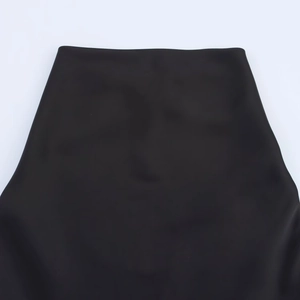 Detail of high waist black satin dress showing premium fabric texture and clean stitching