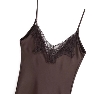 Detail of V-neckline with black floral lace trim on a brown satin dress with thin straps