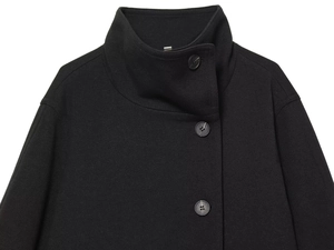 Macro detail of the high-quality black wool coat with stand collar and buttons
