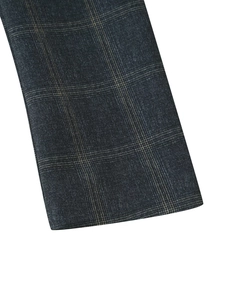 Close-up of the high-quality navy plaid fabric texture on a fashion street blazer