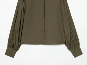 Detail of olive green poplin shirt with puff sleeves and wide elastic cuffs