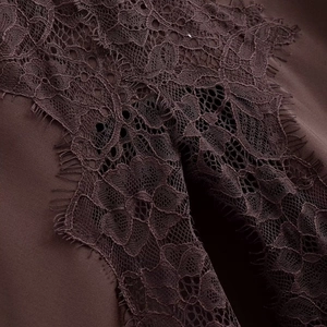 Detail shot of the deep wine red fabric with black eyelash lace trim and fine stitching