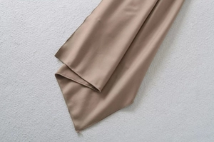 Detailed view of the brown velvet fabric hem showing high-quality stitching and texture