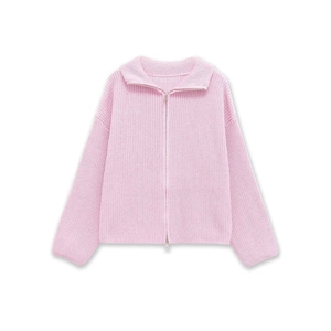 Macro view of light pink ribbed knit texture and full length metal zipper detail
