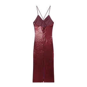 Sparkly burgundy sequin slip dress with cross straps and back slit on a white background
