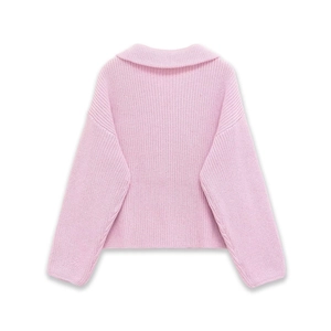 Detailed macro view of the soft pink knit sweater with wide collar and ribbed texture