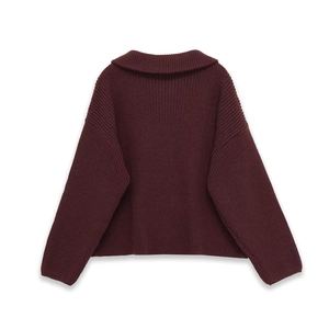 Macro detail of burgundy chunky knit texture and wide collar on back of striped sweater