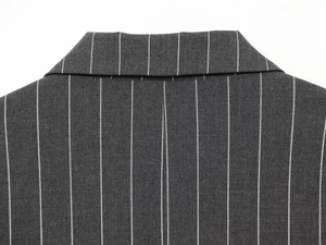 Detail of pinstripe pattern on dark grey blazer collar with premium stitching quality
