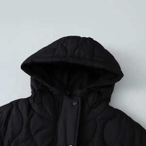 Detail of black quilted jacket with round onion stitching and adjustable drawstring hood