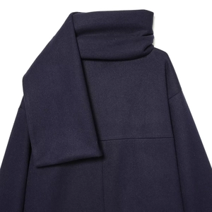Navy blue wool blend coat with integrated scarf collar for women in a clean studio shot