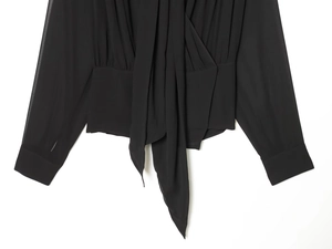 Detail of elegant wrap V-neckline and tie waist on this black chiffon long sleeve blouse