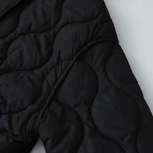 Close-up of diamond quilted waterproof jacket showing wave stitching and smooth texture
