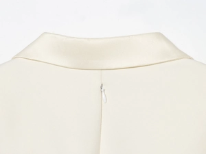 Detail view of the cream white blazer dress featuring a smooth satin collar and hidden back zipper