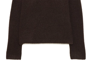 Detailed view of the ribbed hem and cuffs on a dark brown long-sleeve knit sweater