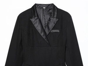 Detail of structured waist with vertical stitching on black tuxedo jacket dress