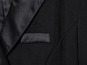 Detail of satin peaked lapel and breast pocket with black rhinestones on a blazer dress