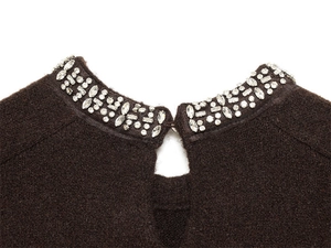 Detailed view of dark brown knitwear collar with keyhole cutout and crystal rhinestones