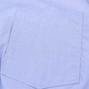 Detailed macro view of patch pocket with V-stitch and fine cotton fabric texture
