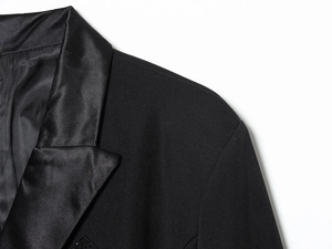 Detail shot showing the contrast between the satin lapel and matte fabric of this black blazer
