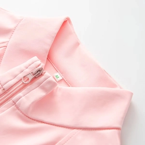Detailed view of pink stand collar bodysuit with zipper and size M label on white background