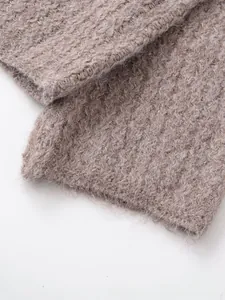 Close-up of taupe knit sweater showing fluffy mohair texture and metallic thread details