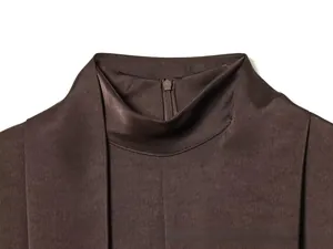 Detail of high collar satin dress in dark brown with hidden back zipper and smooth texture