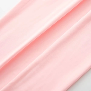 Close-up of pink long sleeve bodysuit showing smooth silky texture and fine fabric details