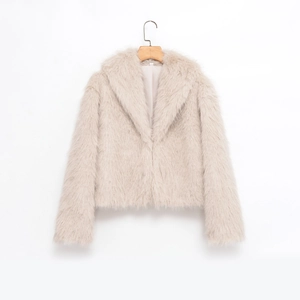 Detailed close-up of light beige faux fur coat featuring a soft texture and lapel collar