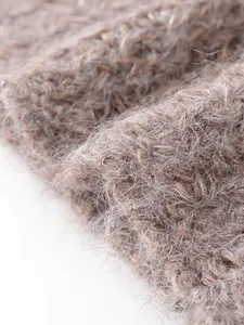 Macro detail of soft grey-brown mohair knit fabric showing plush hairy texture