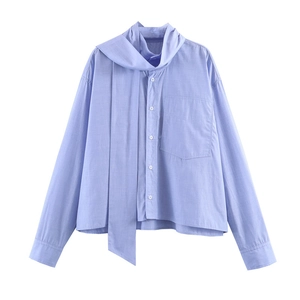 Relaxed light blue long-sleeve shirt featuring a large bow-tie neck and front chest pocket