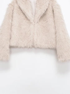 Close-up of thick beige faux fur texture and classic lapel collar on winter coat
