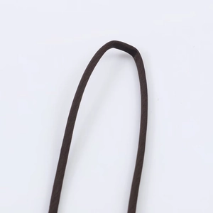 Detailed close-up of dark brown satin dress strap showing soft fabric texture and fine weaving