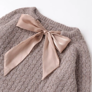 Pink chunky knit sweater for women featuring a large satin ribbon bow detail