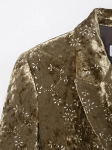 Detailed close-up of olive velvet blazer featuring metallic silver starburst prints