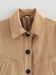 Macro shot of faux suede jacket showing contrast buttons and topstitching details