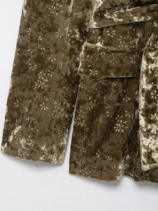 Detail of olive velvet blazer with silver floral print, waist belt and flap pocket texture