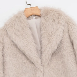 Short faux fur coat with lapel collar in beige color shown on a wooden hanger